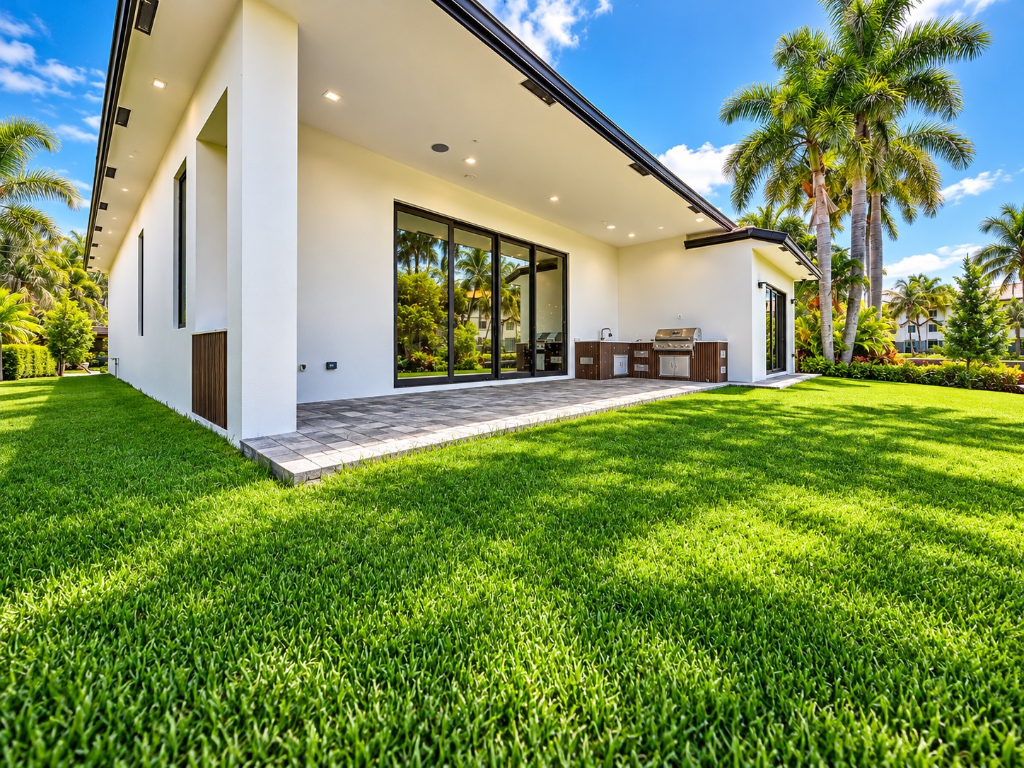 Rear of the house with covered terrace and lawn